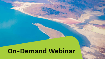 Aerial view showcasing a vast desert landscape with patches of water.