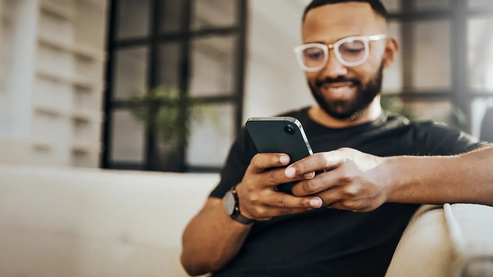 industry professional smiling while looking at his phone