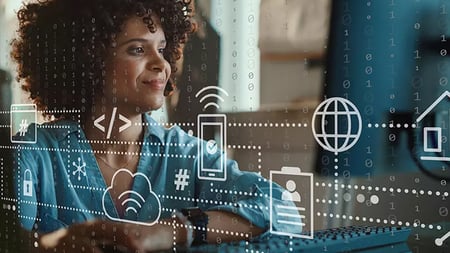 Woman at a desk with technology connected