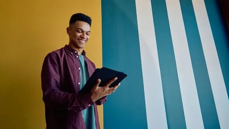 smiling man using a tablet computer