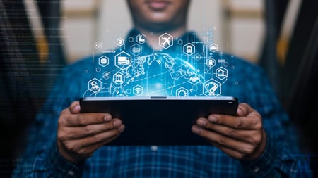 man holding a tablet computer with an overlay of symbols coming out of the screen