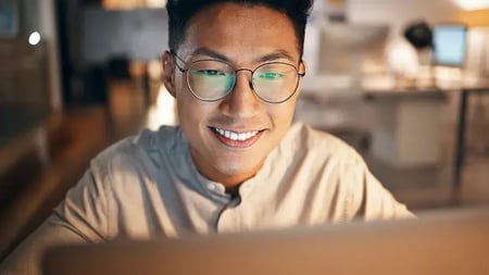 Laptop, information technology and business man in night office for web design, software development or IT code analysis