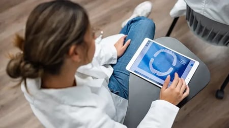dental assistant using a tablet computer
