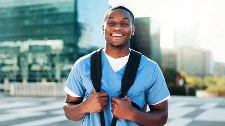 medical assistant student wearing a backpack and smiling