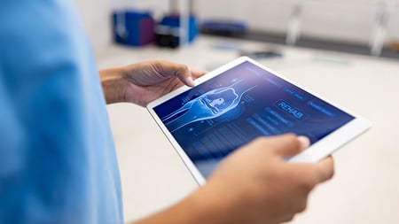 sport medicine professional using a tablet computer