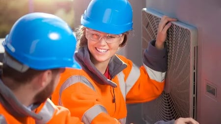 hvac professionals servicing an outdoor unit