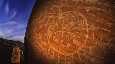 Ancient writing on a rock under the nights sky
