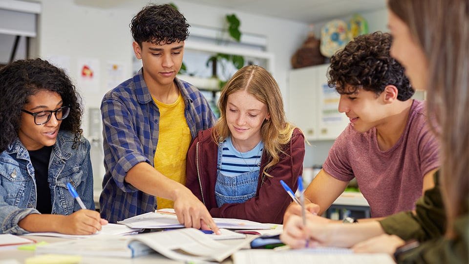 Diverse teenagers students group collaborating during a study session in classroom