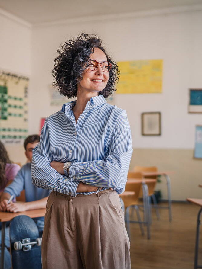 proud teacher standing in her classroom