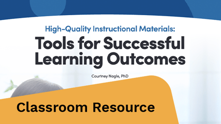 A teacher sitting at a desk.