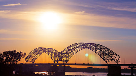 View of Mississippi River and Hernando de Soto Interstate 40 Bridge between downtown Memphis and Arkansas at dusk near Mud Island